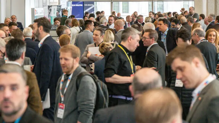 Large crowd networking at an exhibition
