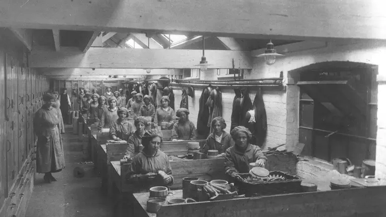 Black and white photo of people working in James Dawson factory, World War One.