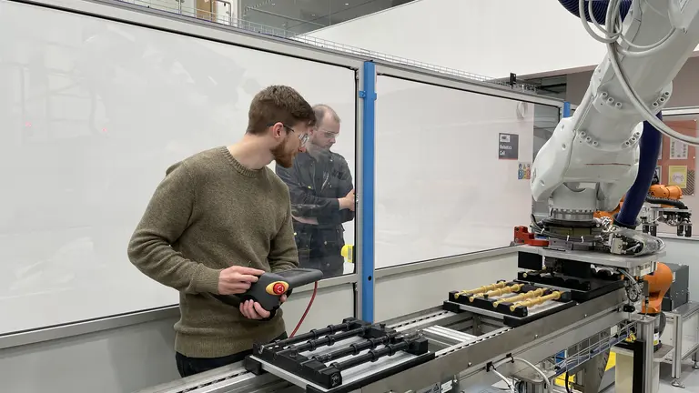 Apprentice working with machines while supervised