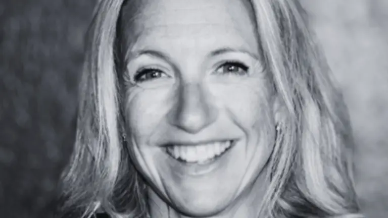 A smiling woman wearing a black t-shirt.