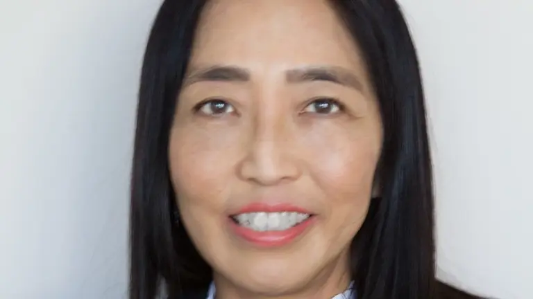 Portrait of a woman with black hair and a black top.