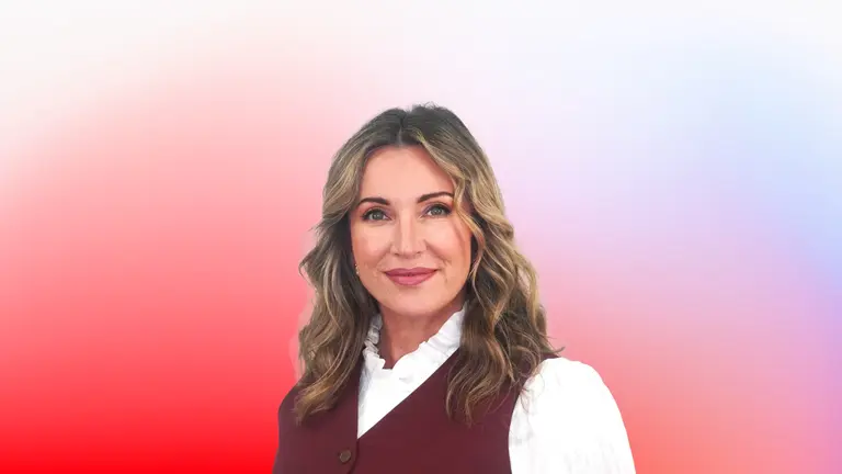 Smiling woman wearing a maroon vest over a white shirt.