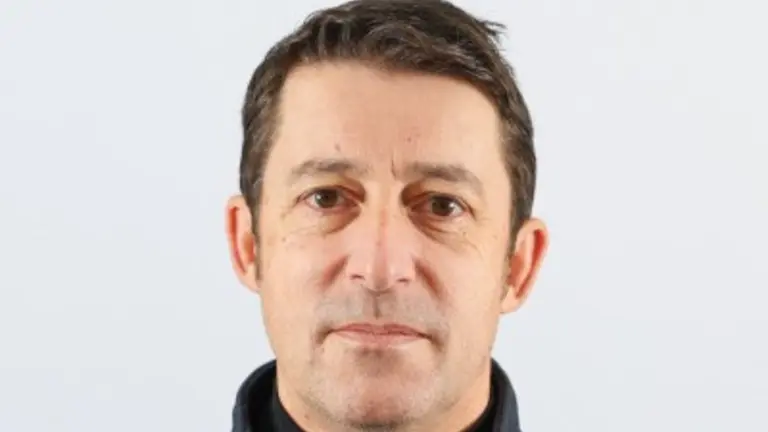 Man in black fleece jacket looking at the camera.