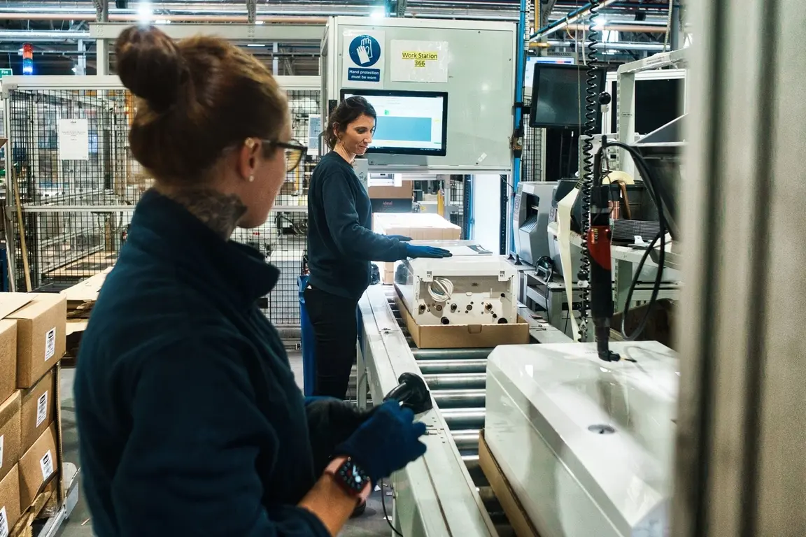 Two female workers assemble boiler at Ideal Heating