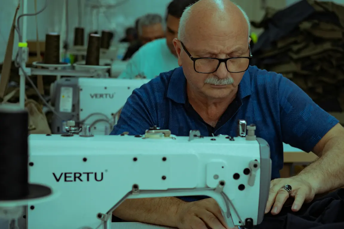 Image of an older worker operating a sewing machine