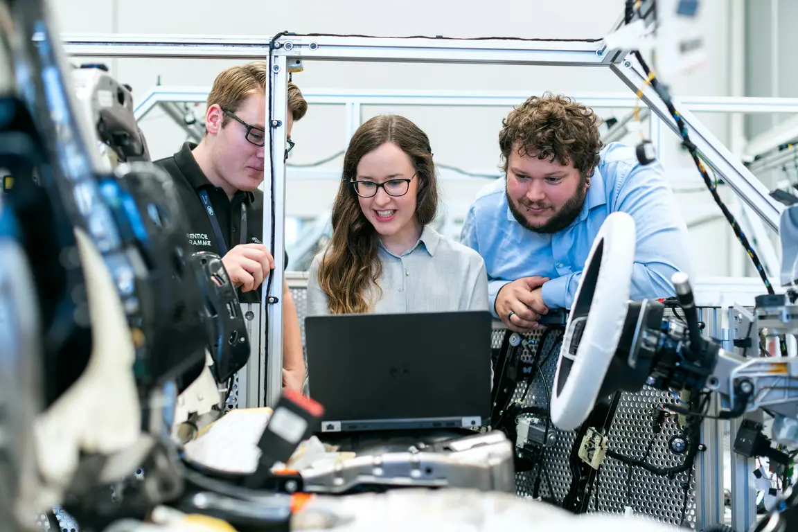 Image of three Engineering workers looking at a computer screen