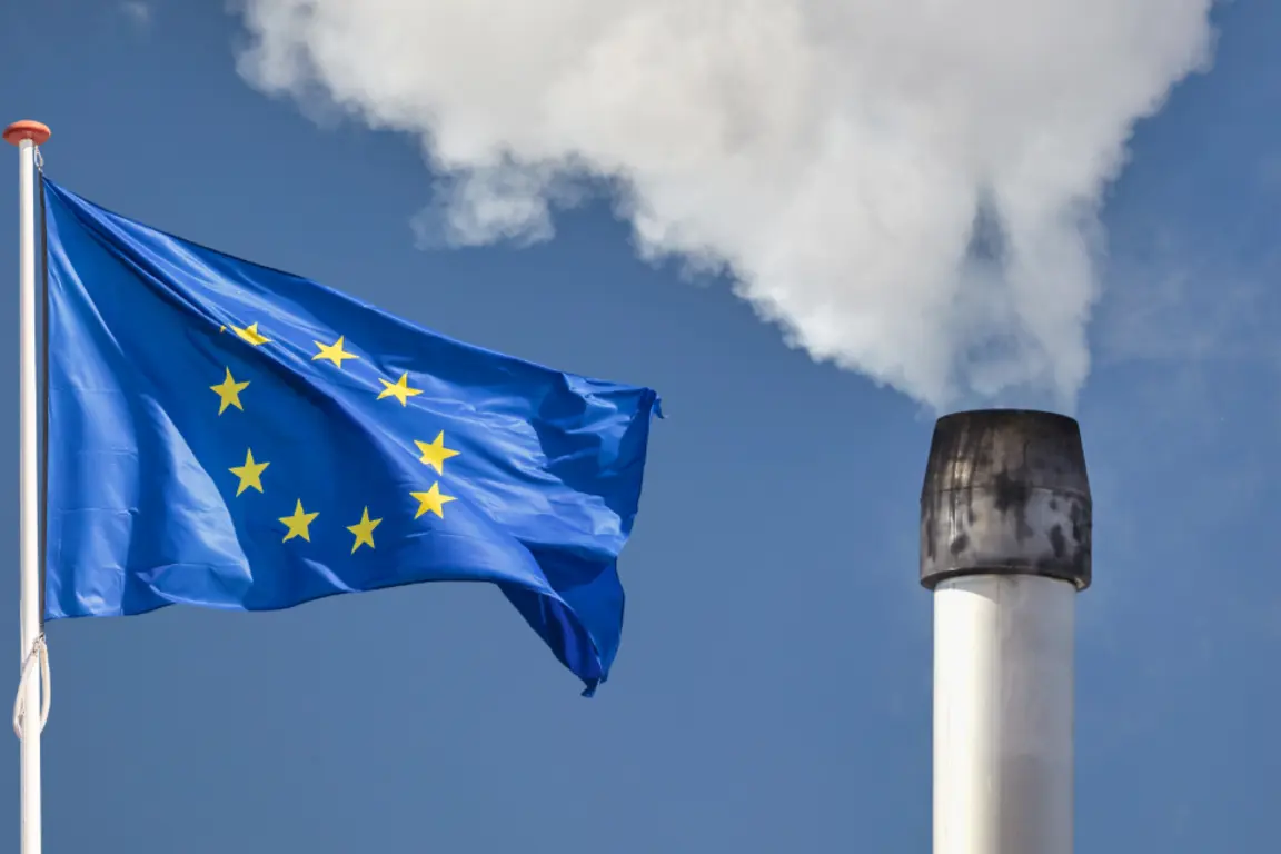 European flag alongside industrial chimney