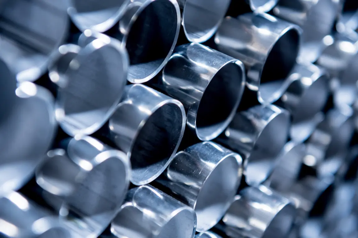 Close-up of polished silver tubes in a pile.