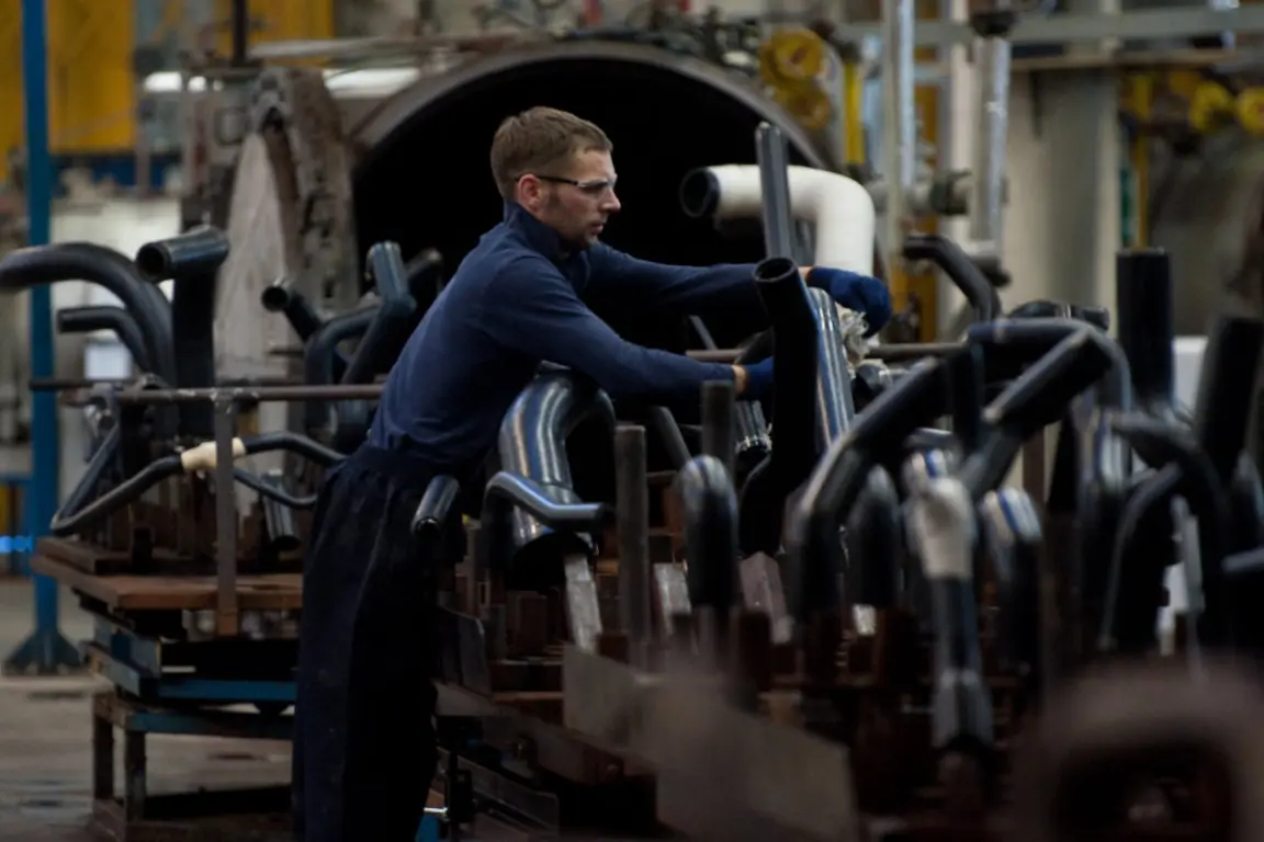 A worker in James Dawson factory with machinery around him