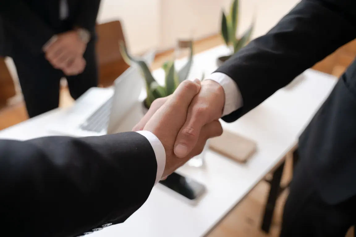Close up of a handshake between two people in a business setting