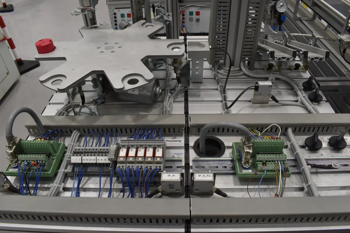 A large, gray, mechanical assembly with various switches, wires, and components.