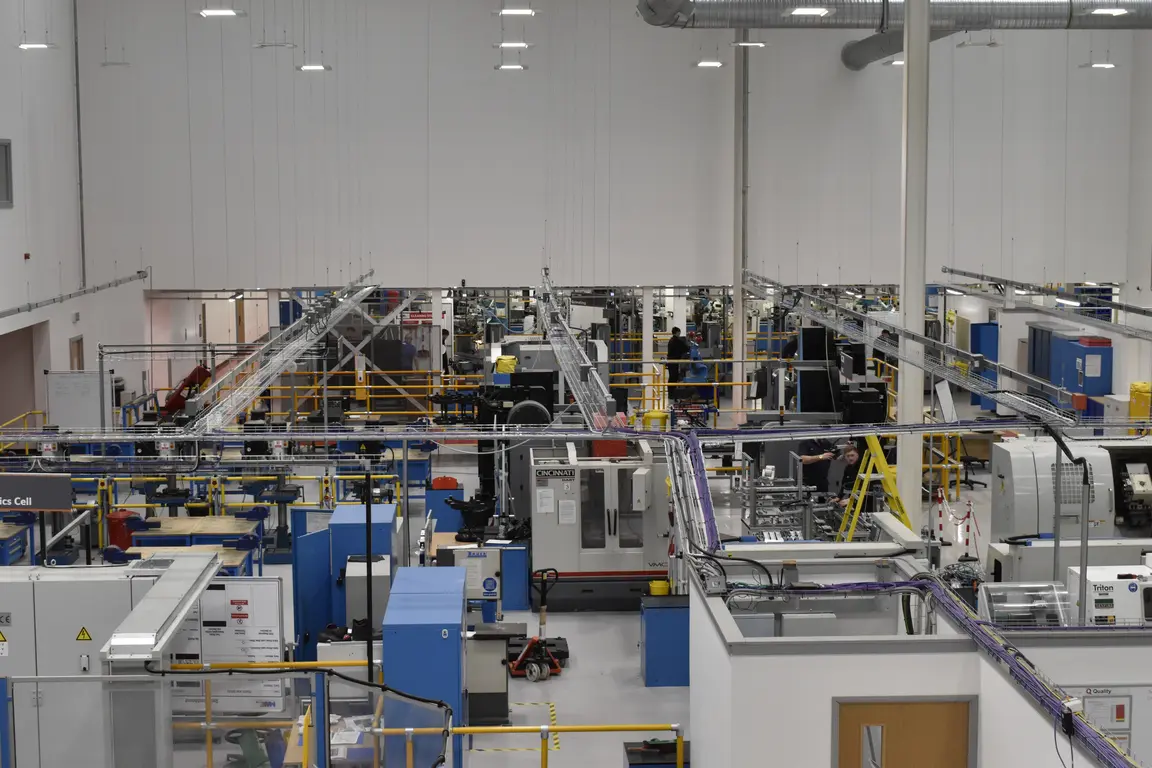 Inside an industrial factory with various machinery and equipment.