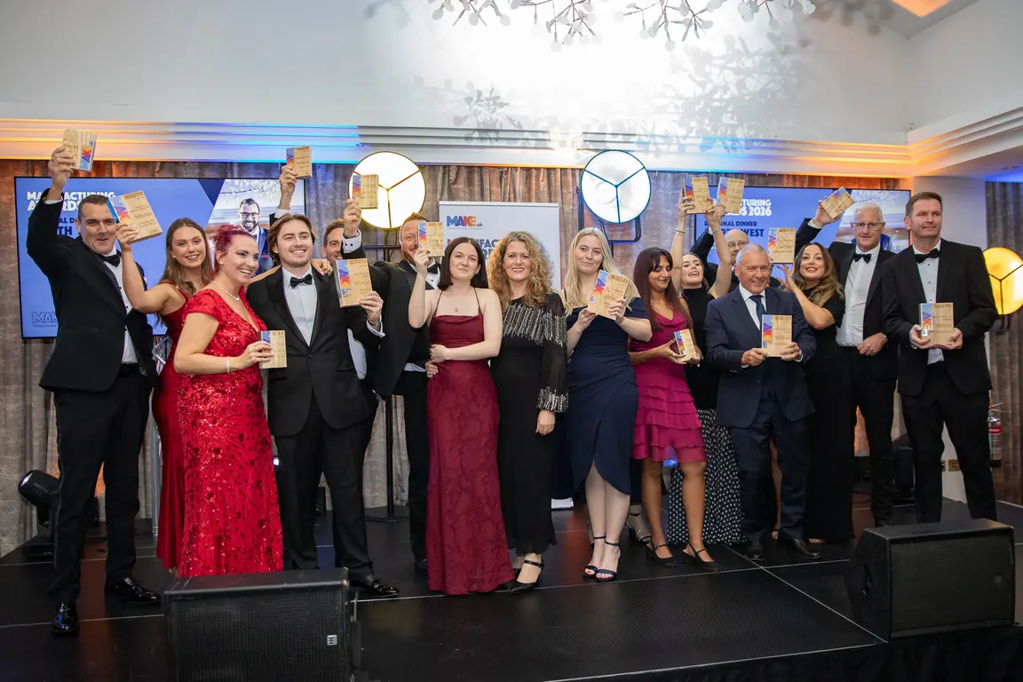 A group of people on a stage holding awards.