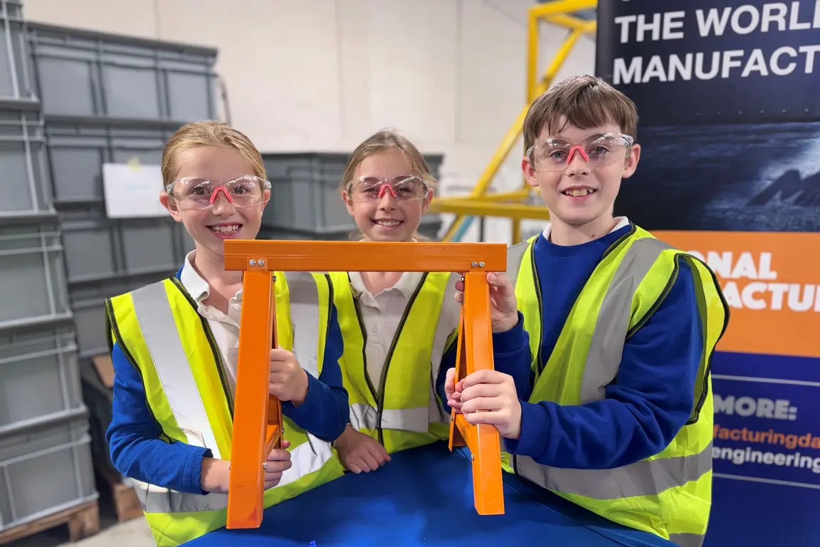 Schoolchildren building frame at Acres Engineering on NMD