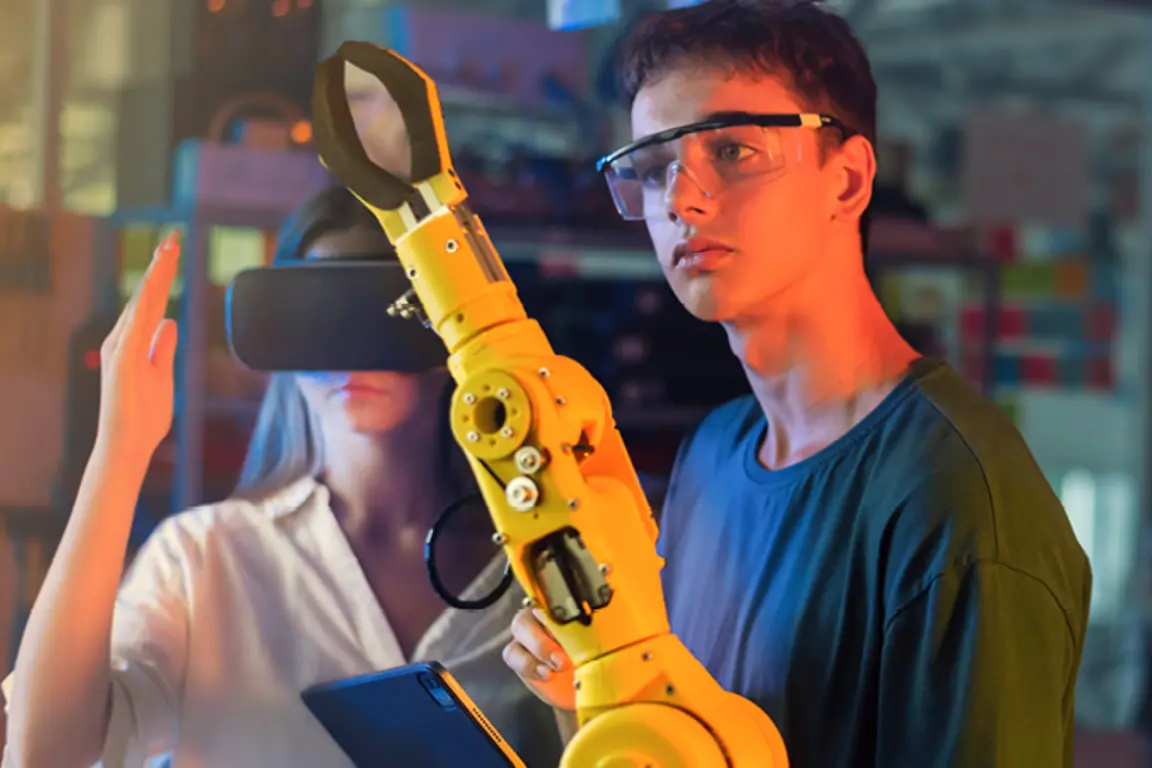 Web banner man in safety goggles looking at robotic arm