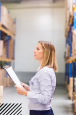 Woman completing survey in warehouse