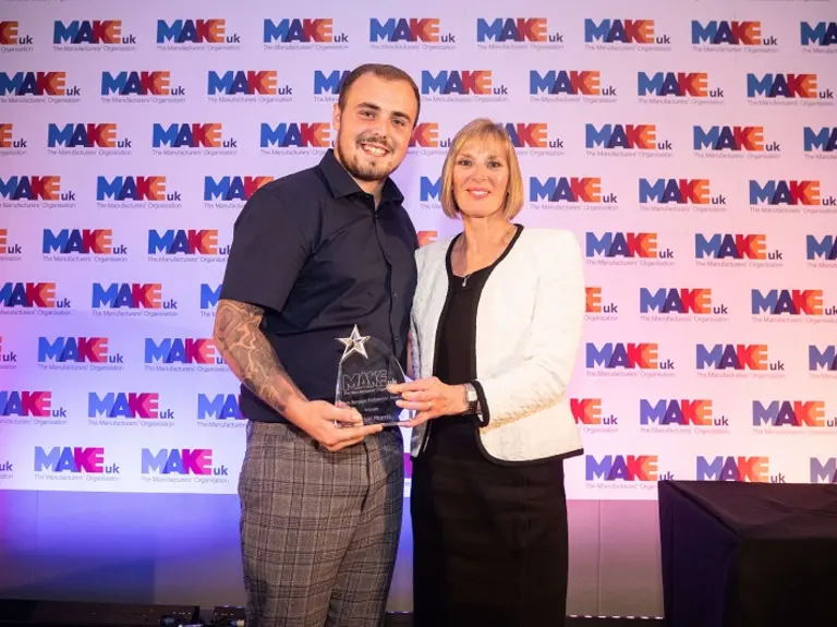 Declan Morris receiving the Mark Burgess Endeavour Award from Sara Cole